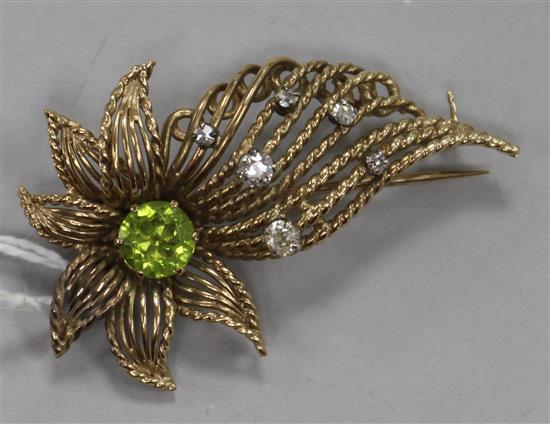 A yellow metal, peridot and diamond set floral spray brooch, 52mm.